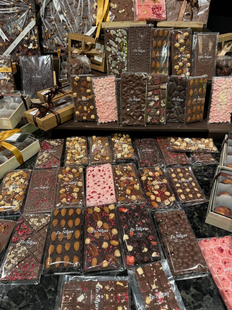 Rows of wrapped artisan chocolate bars laid out on a market table