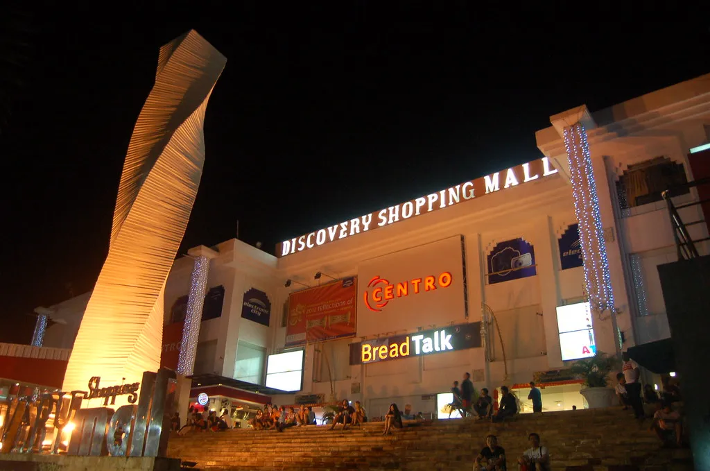 The lit facade of Discovery Shopping Mall in Kuta after dark